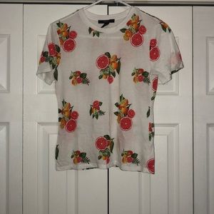 White t-shirt with oranges and pomegranates on it.